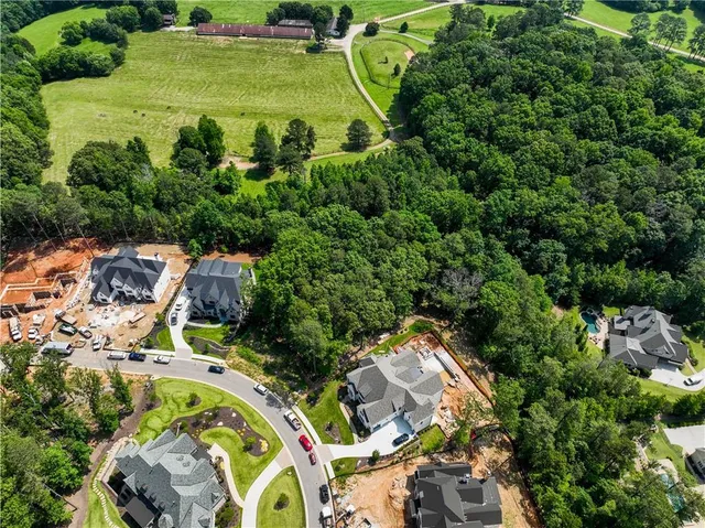 an aerial view of a house with a yard basket ball court and outdoor seating