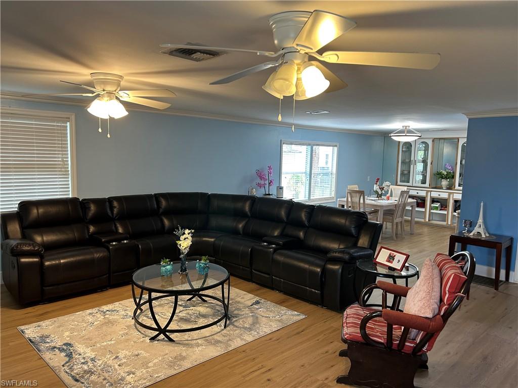 181 Pine Key Lane, Unit 29 Naples, FL 34114 - Photo 1 of 20 Living room with ornamental molding, vinyl finished floors, and ceiling fan