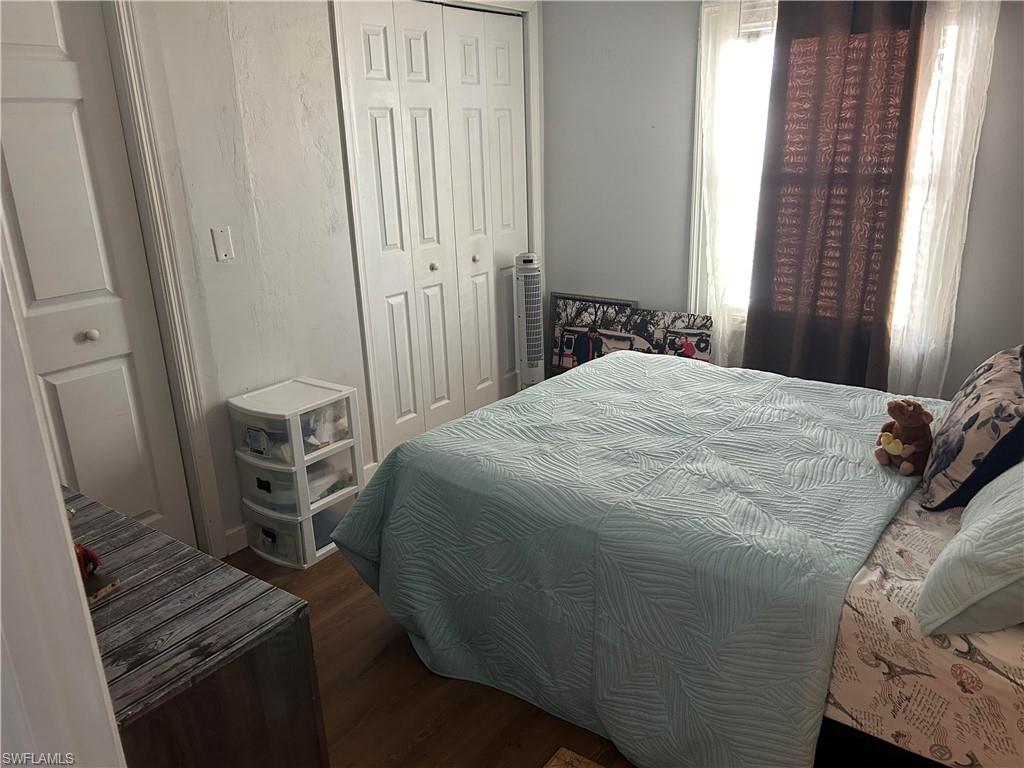 181 Pine Key Lane, Unit 29 Naples, FL 34114 - Photo 12 of 20 Bedroom featuring dark wood-type flooring and a closet