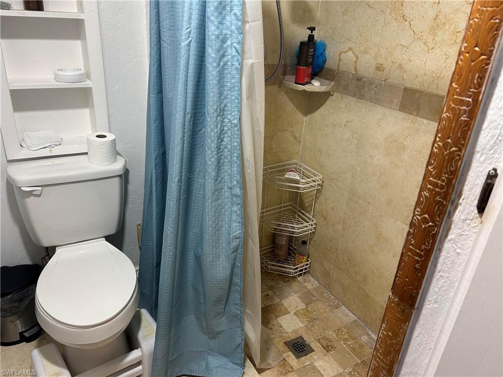 181 Pine Key Lane, Unit 29 Naples, FL 34114 - Photo 14 of 20 Full bath with a shower stall and toilet