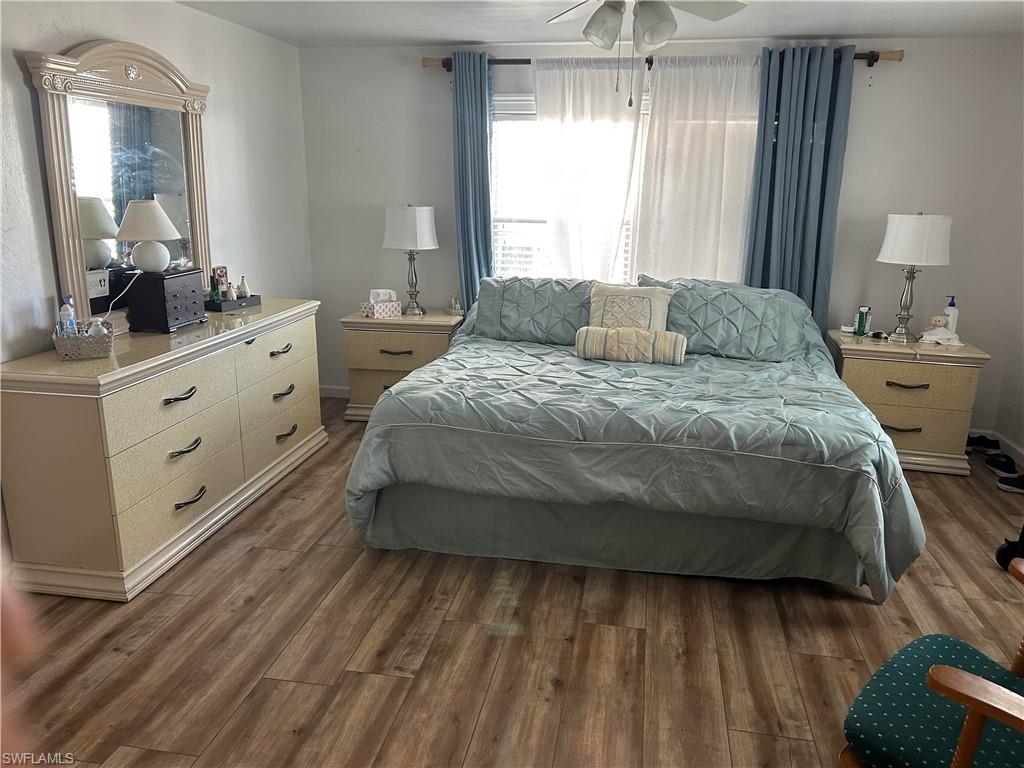 181 Pine Key Lane, Unit 29 Naples, FL 34114 - Photo 16 of 20 Bedroom featuring dark wood-style floors and ceiling fan