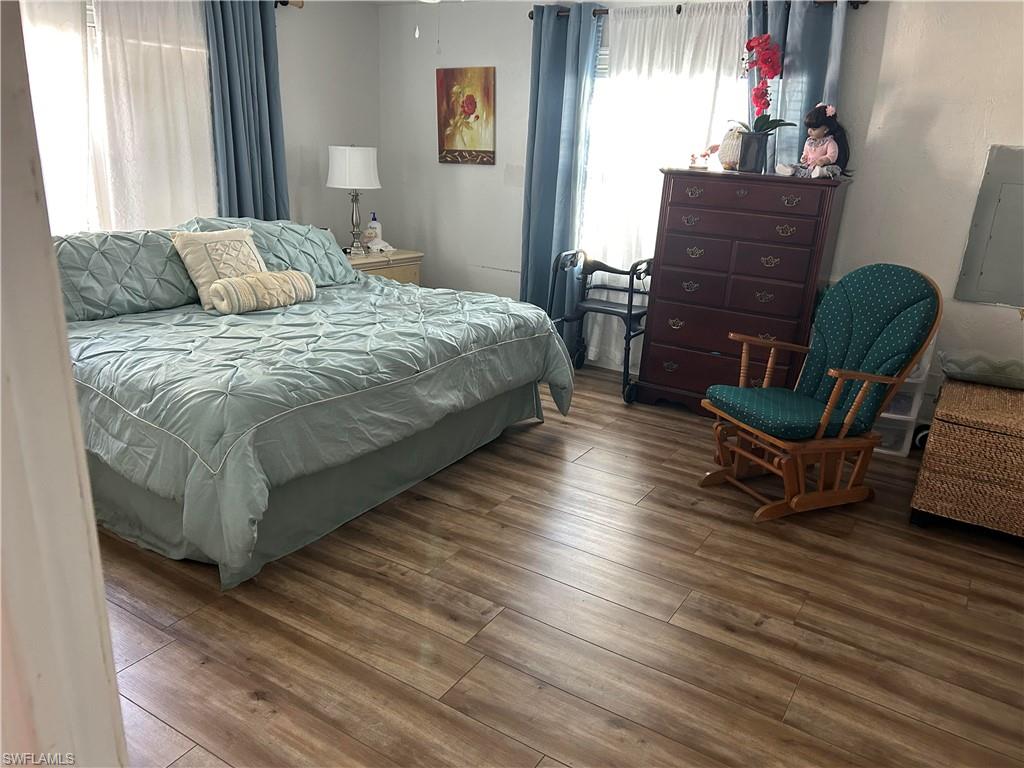 181 Pine Key Lane, Unit 29 Naples, FL 34114 - Photo 17 of 20 Bedroom featuring hardwood / wood-style flooring and electric panel