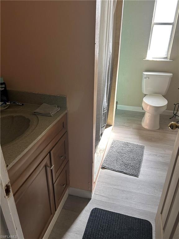 181 Pine Key Lane, Unit 29 Naples, FL 34114 - Photo 18 of 20 Bathroom with vanity, a shower with shower curtain, and light wood finished floors