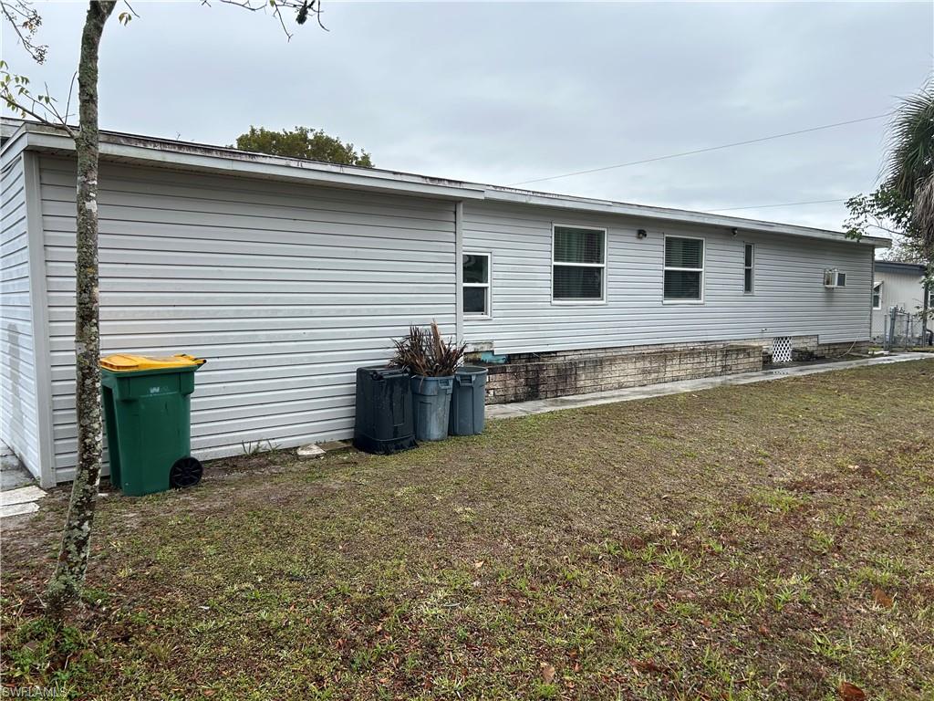 181 Pine Key Lane, Unit 29 Naples, FL 34114 - Photo 3 of 20 View of home's exterior with a lawn and a patio