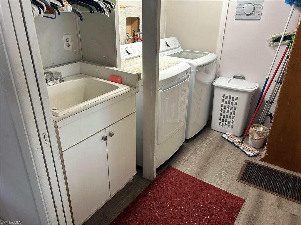 181 Pine Key Lane, Unit 29 Naples, FL 34114 - Photo 10 of 20 Laundry area featuring light wood-type flooring and independent washer and dryer