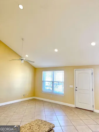 an empty room with windows and closet