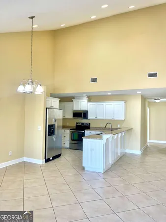 a view of a kitchen with a sink stainless steel appliances and cabinets