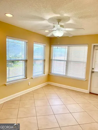 a view of an empty room with a chandeliers