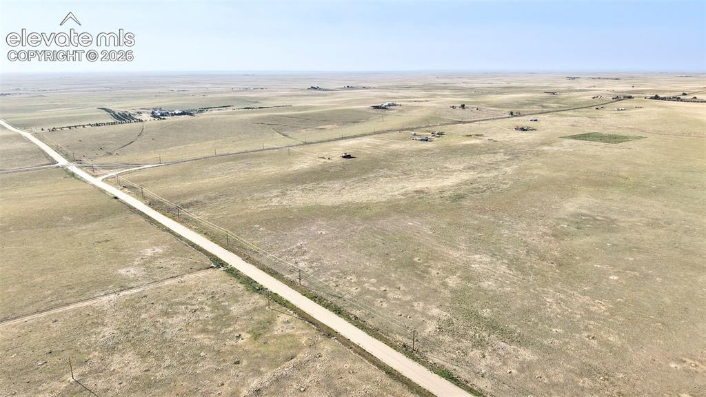 9670 Boone Road Yoder, CO 80864 - Photo 5 of 18 Expansive land featuring a dirt road, open fields, and distant structures