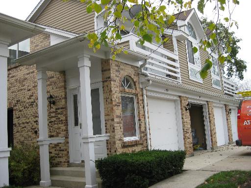 1197 Ranchview Court, Unit 1197 Buffalo Grove, IL 60089 - Photo 1 of 6 a front view of a house with a garden