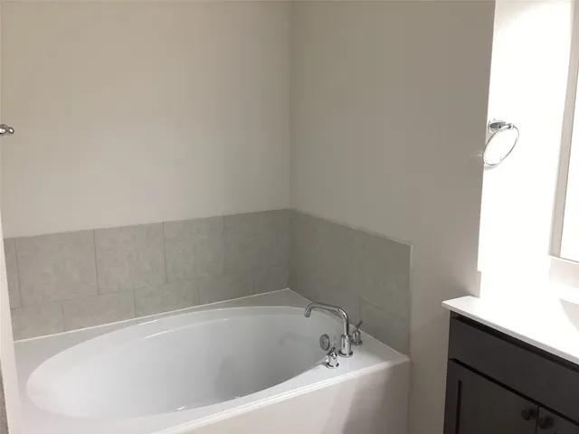 a white bath tub sitting in a bathroom