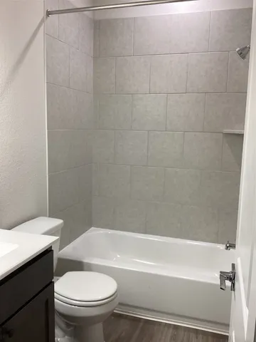a bathroom with a toilet and a bath tub