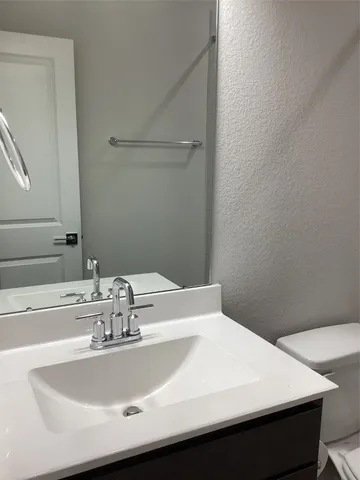 a bathroom with a sink a vanity and a mirror