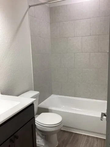 a bathroom with a sink a toilet and a bathtub