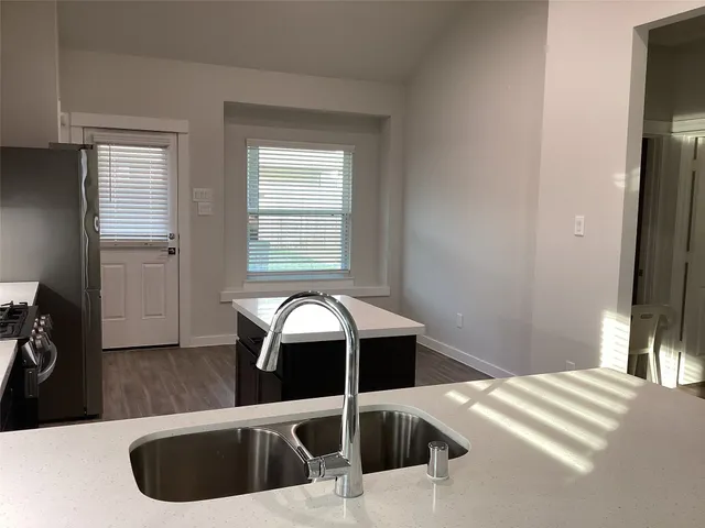 a kitchen with a refrigerator and a sink