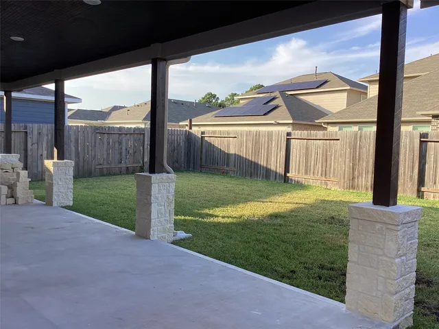 a view of a house with a big yard and a large tree