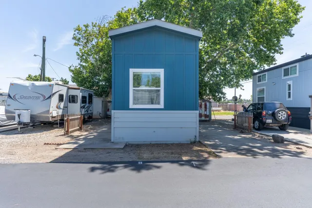 a view of a house with a yard and sitting area
