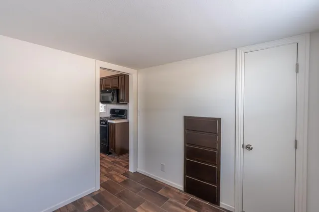 a view of an entryway with wooden floor