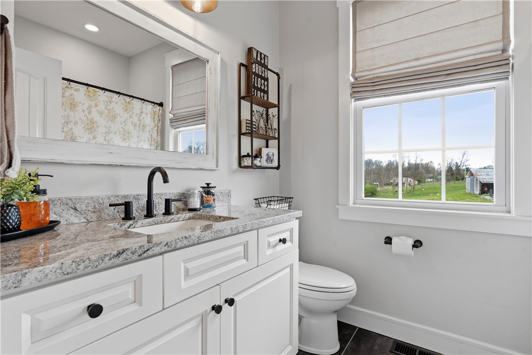 1158 Pyle Road Clarksville, OH 45113 - Photo 37 of 76 This bright bathroom features sleek granite counters and modern fixtures, perfect for daily routines.
