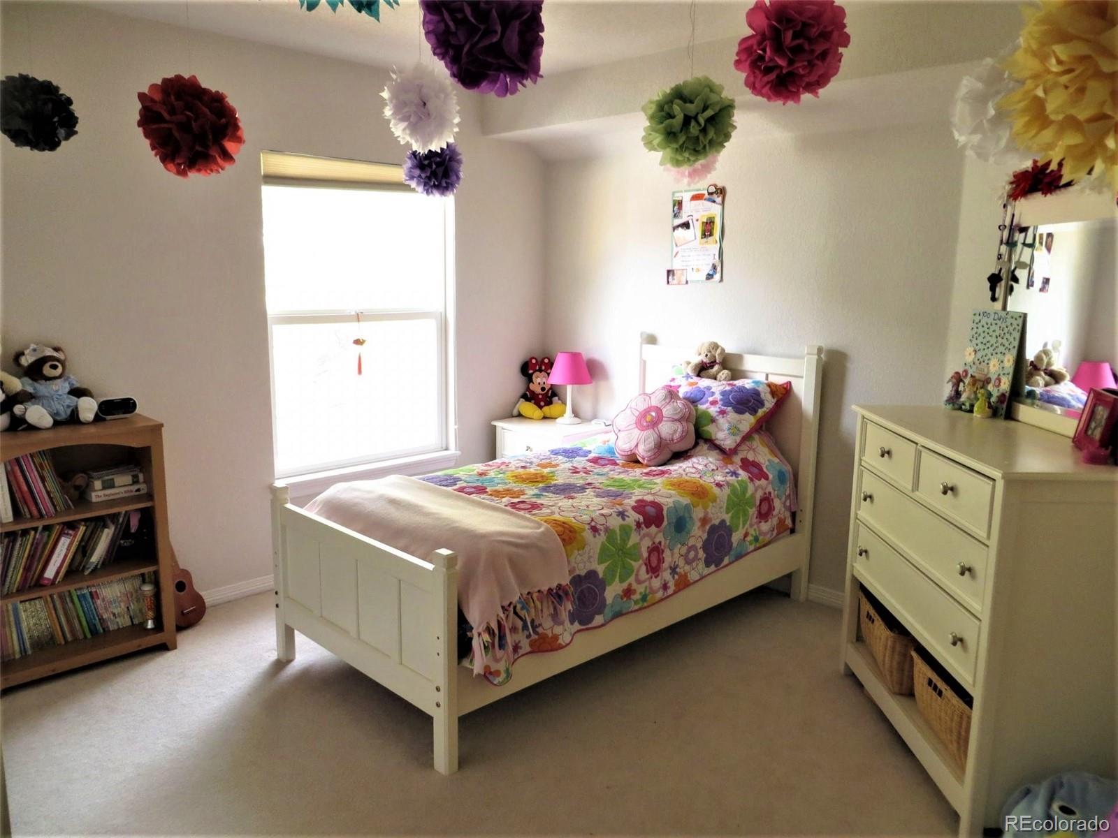 455 West Angus Way Highlands Ranch, CO 80129 - Photo 20 of 27 a bedroom with a bed and a window