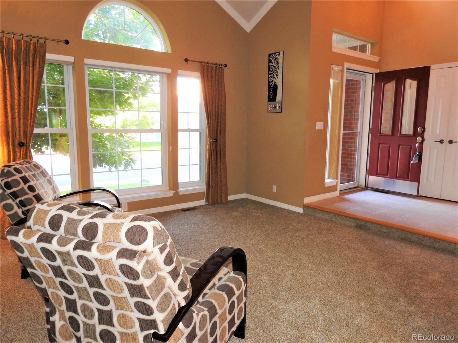 455 West Angus Way Highlands Ranch, CO 80129 - Photo 3 of 27 a bedroom with a bed and a window