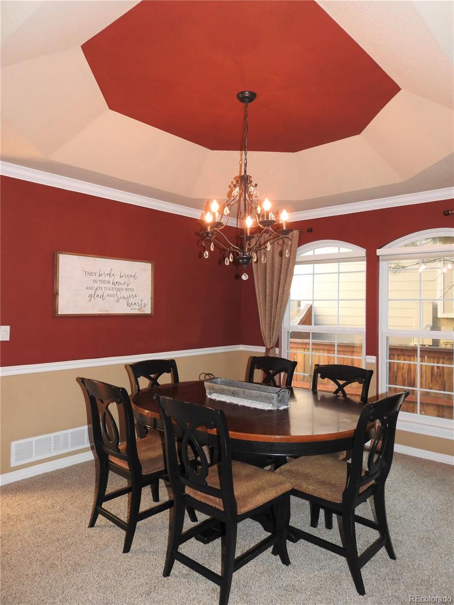 455 West Angus Way Highlands Ranch, CO 80129 - Photo 4 of 27 a view of a dining room with furniture window and chandelier