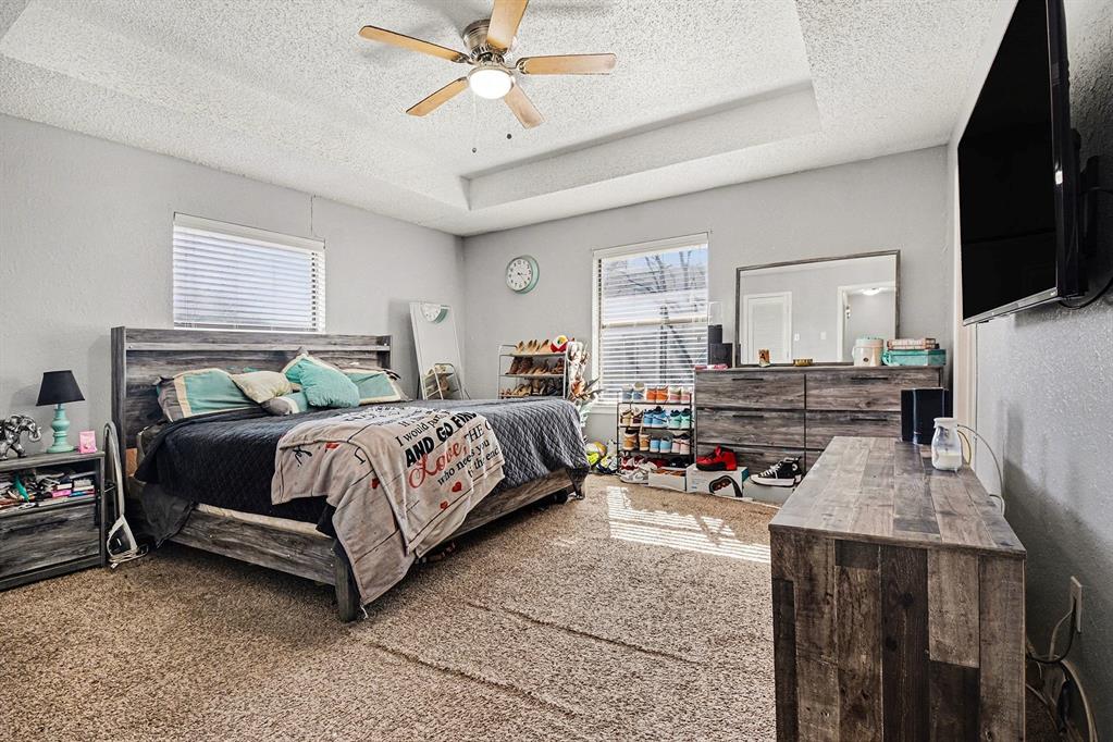 2433 Hallmark Street Grand Prairie, TX 75052 - Photo 12 of 15 a bedroom with a bed a couch and dresser