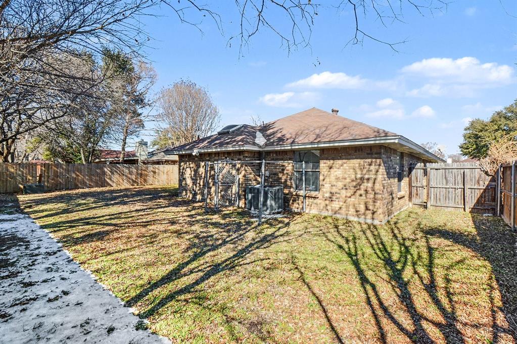2433 Hallmark Street Grand Prairie, TX 75052 - Photo 14 of 15 a view of a house with a yard and sitting area