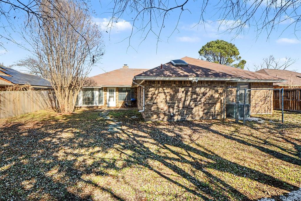 2433 Hallmark Street Grand Prairie, TX 75052 - Photo 15 of 15 a front view of a house with a yard