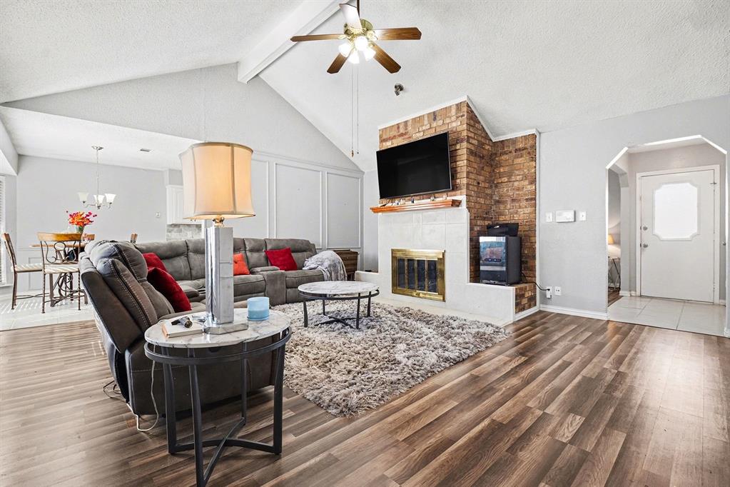2433 Hallmark Street Grand Prairie, TX 75052 - Photo 2 of 15 a living room with furniture a fireplace and a flat screen tv