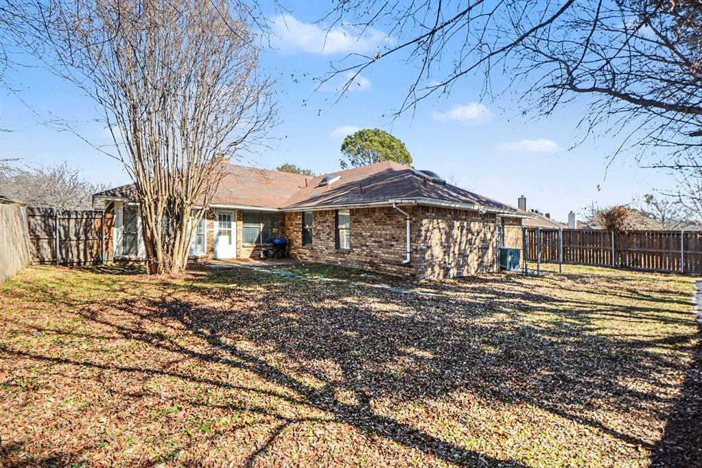 2433 Hallmark Street Grand Prairie, TX 75052 - Photo 6 of 15 a view of a large house with a yard and sitting area