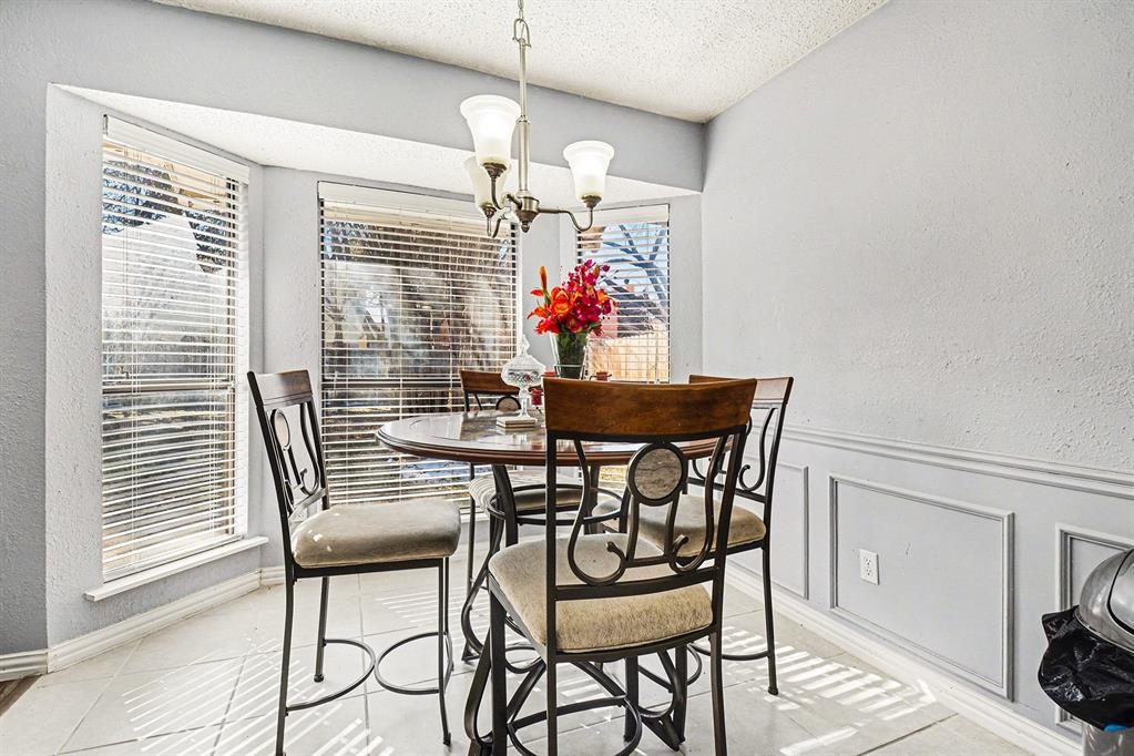 2433 Hallmark Street Grand Prairie, TX 75052 - Photo 8 of 15 a view of a dining room with furniture and chandelier