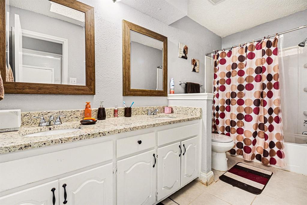 2433 Hallmark Street Grand Prairie, TX 75052 - Photo 10 of 15 a bathroom with a sink and a mirror