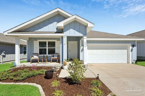 a house view with a sitting space and garden space
