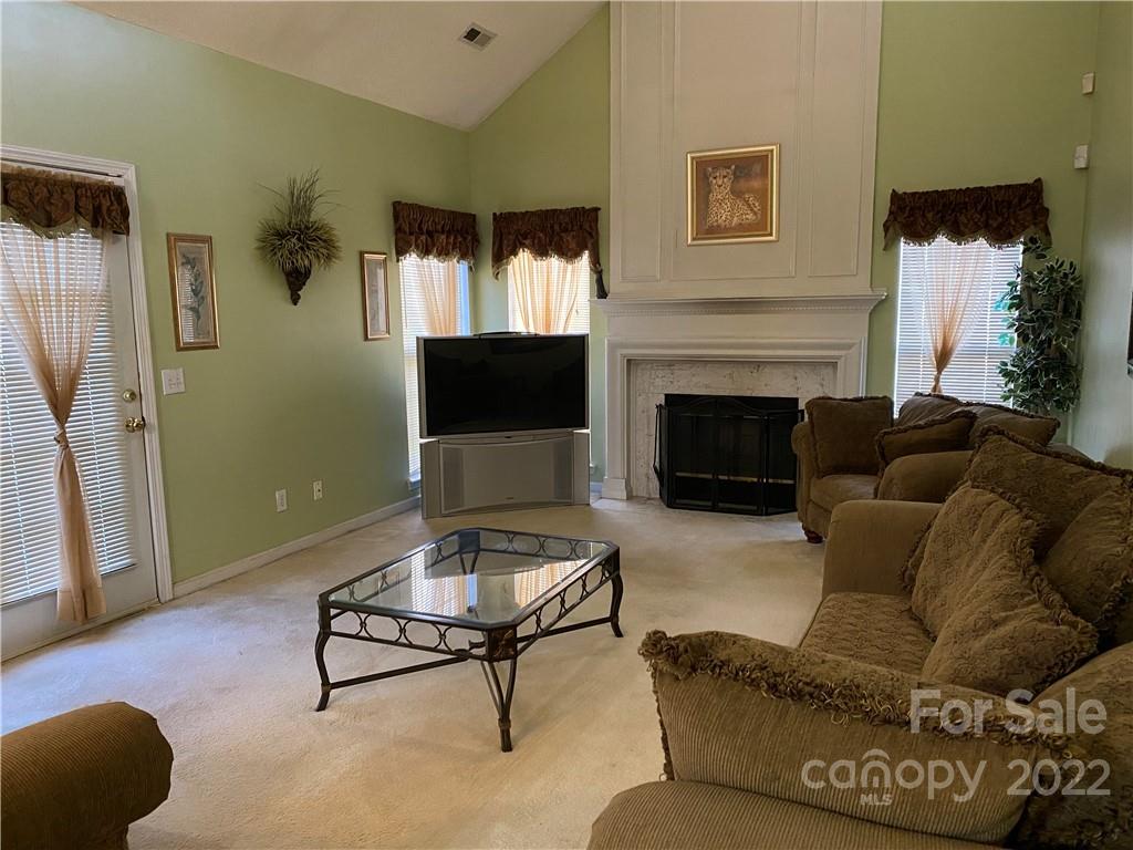 7306 Reedy Creek Road Charlotte, NC 28215 - Photo 2 of 15 a living room with furniture and a fireplace