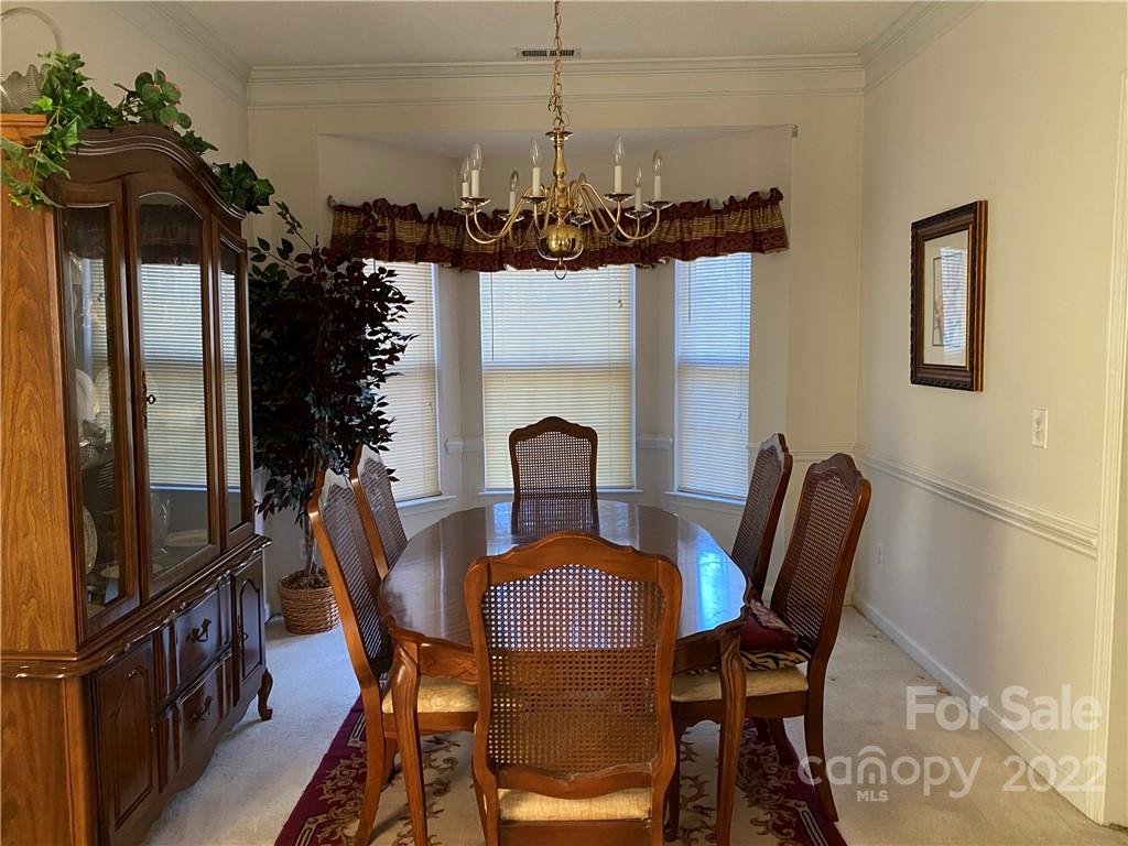 7306 Reedy Creek Road Charlotte, NC 28215 - Photo 4 of 15 a view of a dining room with furniture and wooden floor