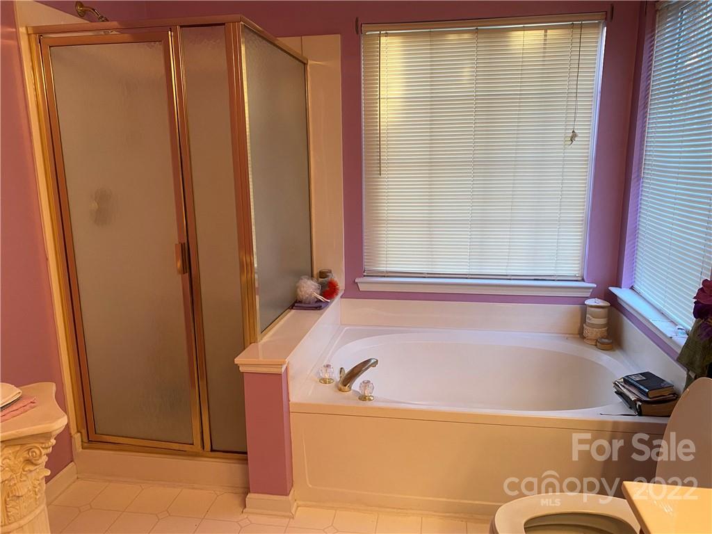7306 Reedy Creek Road Charlotte, NC 28215 - Photo 9 of 15 a bath tub sitting next to a window