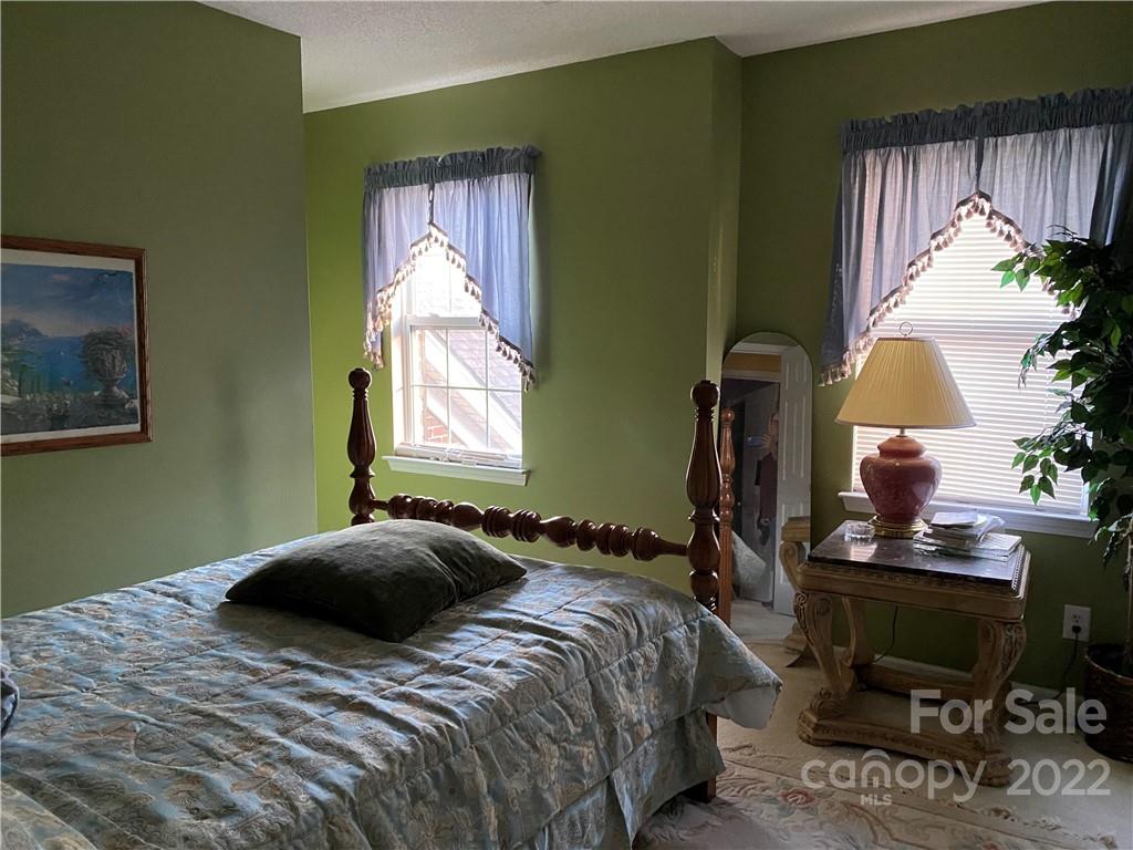 7306 Reedy Creek Road Charlotte, NC 28215 - Photo 10 of 15 a bedroom with a bed and a window