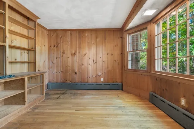 a view of a room with wooden floor and windows