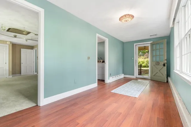 wooden floor in an empty room with a window