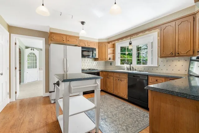 a kitchen with a sink appliances cabinets and a counter top space