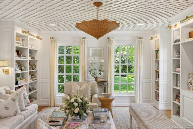 a living room with furniture a flat screen tv and a dining table