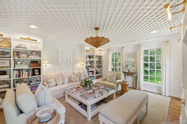 a living room with furniture and large windows