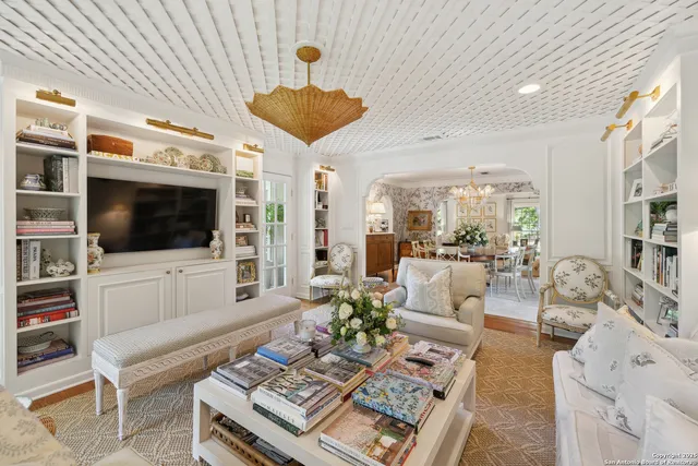 a kitchen with stainless steel appliances granite countertop a sink a stove a refrigerator cabinets and wooden floor