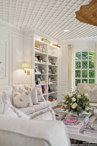 a kitchen with a stove cabinetry a chimney and a table