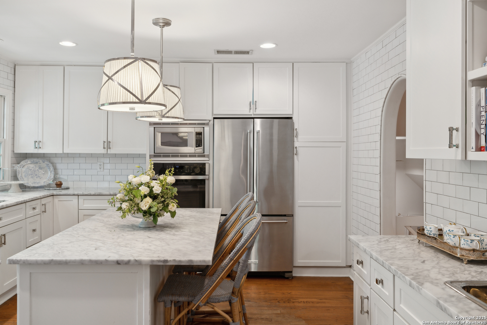 643 Terrell Road Terrell Hills, TX 78209 - Photo 20 of 60 a kitchen with stainless steel appliances granite countertop a sink a stove a refrigerator cabinets and wooden floor