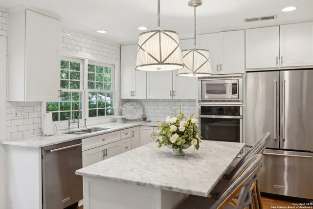a kitchen with cabinets and a wooden floor