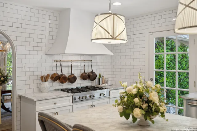a spacious bedroom with bed and a chandelier
