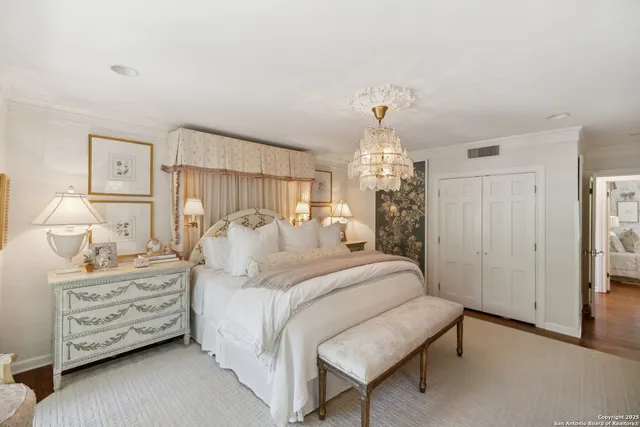 a bedroom with furniture and a large window