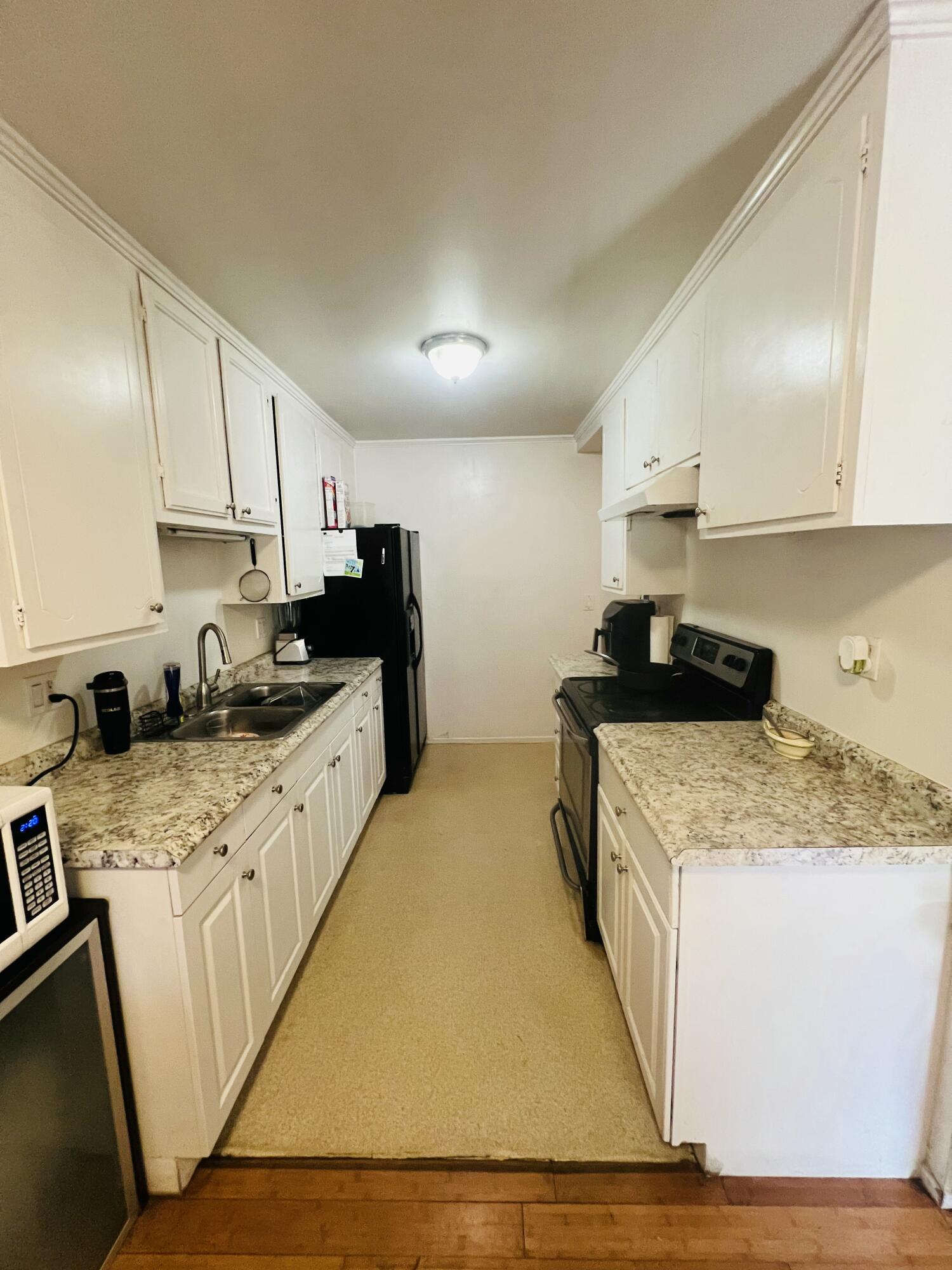 459 Linfield Place Goleta, CA 93117 - Photo 12 of 17 a kitchen with granite countertop a sink stove and cabinets